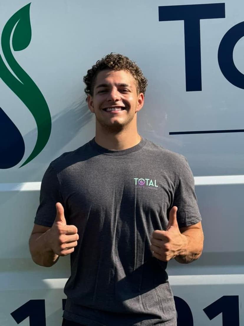 Small home with a windy driveway and green grass